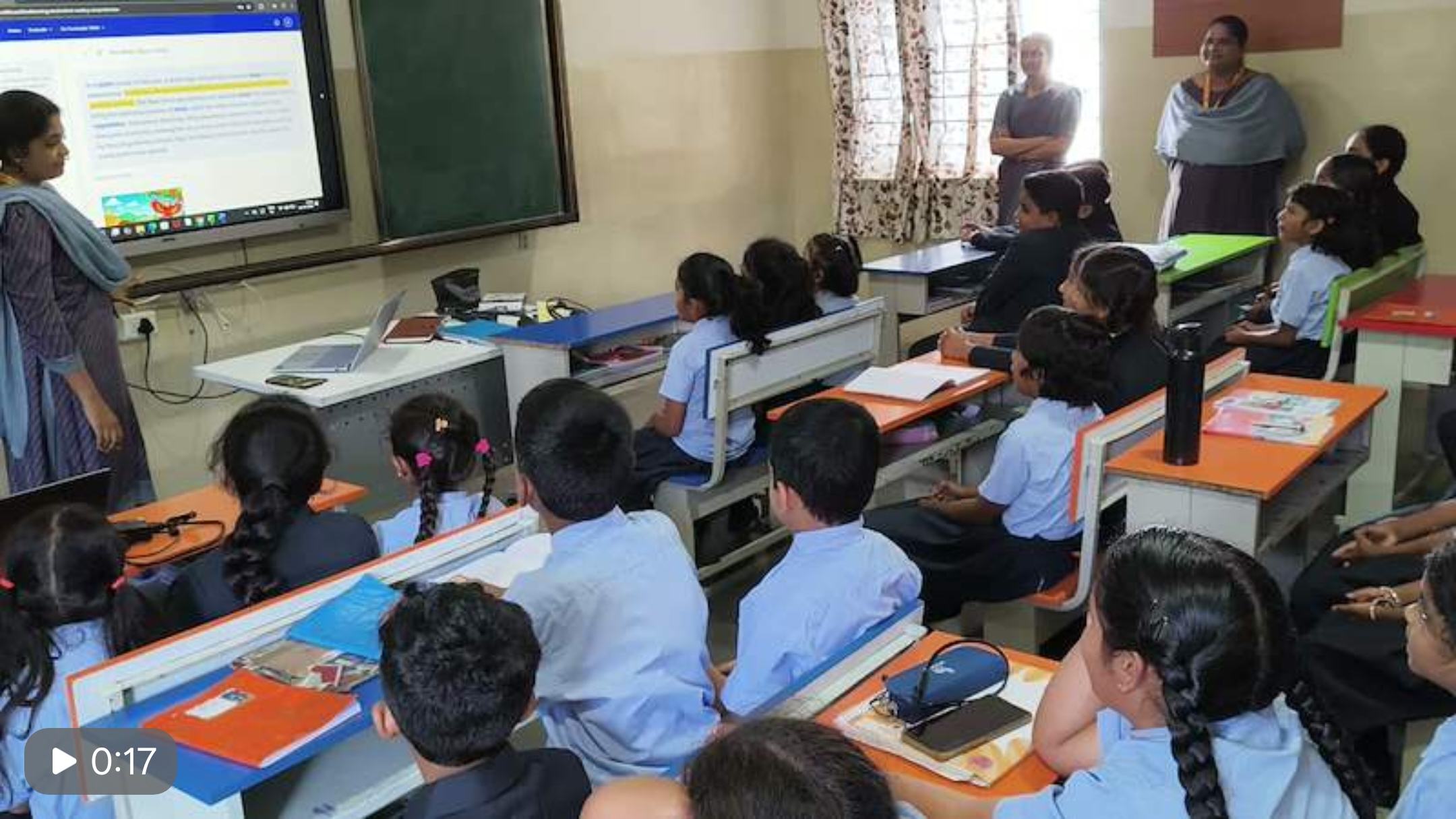 A teacher running a VidyaBuddhi reading session for a full classroom
