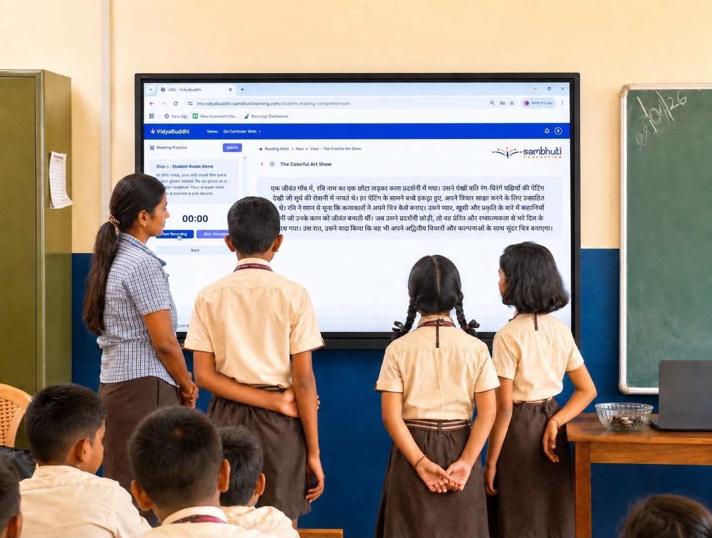 A teacher and students reading a Hindi passage on a VidyaBuddhi smart board